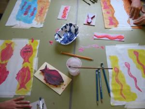 Background painting with block prints made by the children.